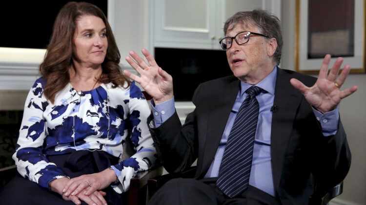 Microsoft co-founder Bill Gates speaks while his wife Melinda looks on during an interview in New York, U.S. on February 22, 2016. REUTERS/Shannon Stapleton/File Photo